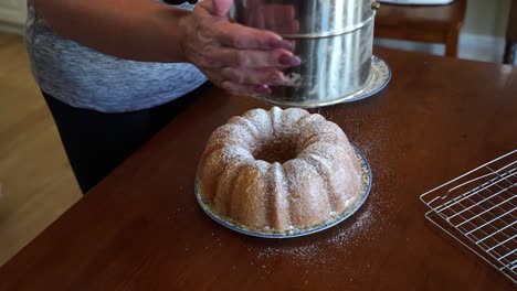 Sprinkling-powdered-sugar-over-a-Kentucky-butter-cake---slow-motion-POUND-CAKE-SERIES