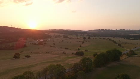 Aerial-Shot-Over-The-Stunning-German-Countryside-Of-Hesse-With-The-Sun-Setting-In-The-Background
