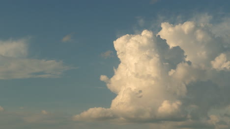 Generic-timelapse-of-fluffy-clouds-forming-and-dissolving,-golden-hour