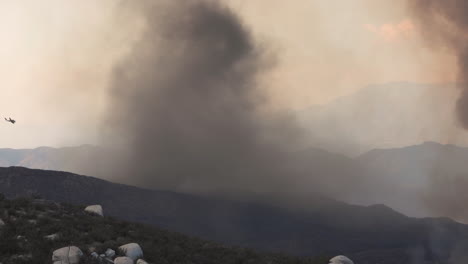 Timelapse-of-dark-smoke-tornado-over-wildfires-on-Californian-hills