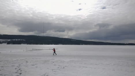 Panning-across-Holiday-Club-Katinkulta-Vuokatti-Finland-person-skiing-through-freezing-resort-landscape