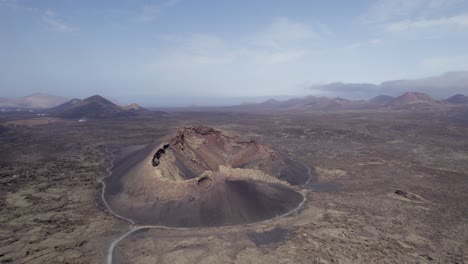 Aerial-shot-of-old-dormant-volcano-and-volcanic-landscape,-Lanzarote-island