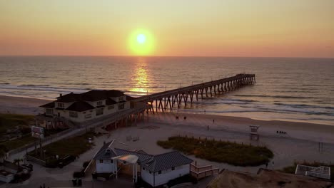 Aerial-fast-zoom-by-pier-at-sunrise-at-wrightsville-beach-nc