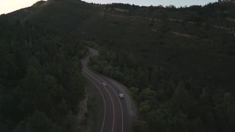 Two-White-Cars-on-Road-in-Forest-of-Sandia-Mountains,-New-Mexico-USA,-Drone-Aerial-View