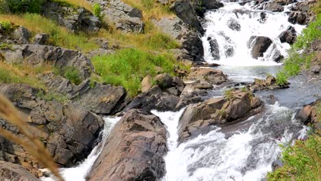 Water-gently-cascades-down-a-rocky-incline-in-a-small-river
