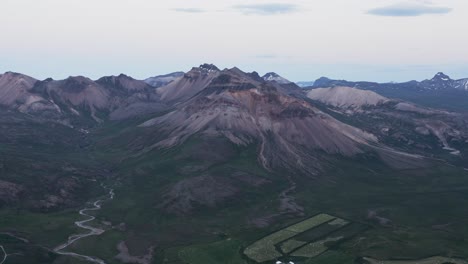 Dreamy-volcanic-mountain-terrain-in-Iceland-during-sunset,-aerial