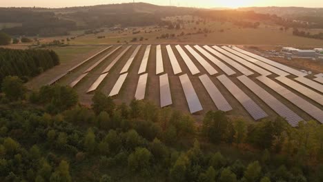 Closing-Side-On-Shot-Of-A-Field-Of-Solar-Panels-With-The-Sunset-Reflecting-Off-The-Panels