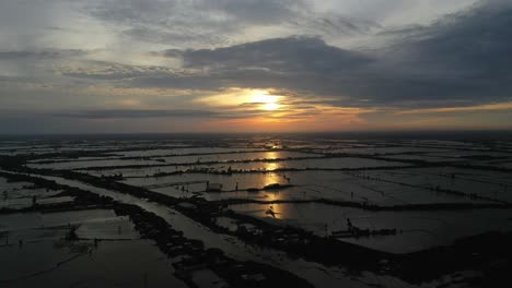 Aerial-view-of-colorful-Mekong-Delta-sunrise-over-agricultural-land-and-waterways-in-Vietnam
