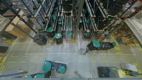 Timelapse-top-down-shot-of-an-industrial-hall,-forklift-truck-operator-drive-with-plastic-cast-in-a-big-retail-warehouse,-Logistics-Product-and-Goods-Delivery-and-Distribution-Center