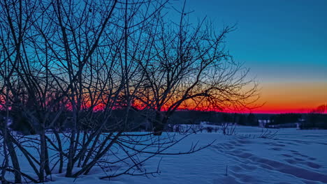 Rot-Gefärbter-Himmel-Während-Der-Sonnenuntergangszeit-Am-Horizont-Während-Des-Kalten-Schneetages-In-Der-Natur---Zeitraffer