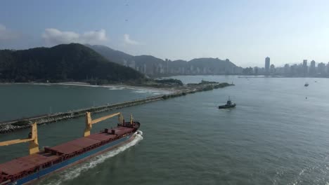 Industrial-Barge-And-Tugboats-Enters-The-Itajai-Acu-River-To-The-Shipping-Terminal-In-Navegantes,-Santa-Catarina,-Brazil