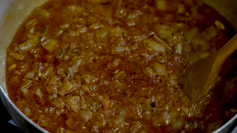 Overhead-close-up-shot-of-a-stock-pot-of-curry-sauce-with-onions-been-cooked-in-a-kitchen