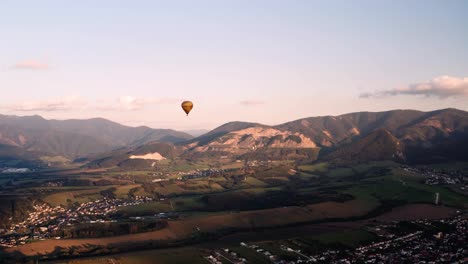 Scenic-aerial-long-shot-of-hot-air-balloon-against-sky-at-sunset