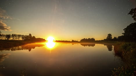 Time-lapse-shot-of-golden-sunset-changing-to-night-with-flying-stars-over-lake-in-nature