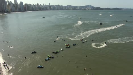 People-Swimming-And-Jet-Skiing-At-The-Beach-During-Summer-In-Balneario-Camboriu,-Brazil