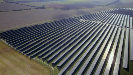 Aerial-Birds-Eye-shot-of-Massive-photovoltaic-solar-farm-in-rural-area---Production-of-renewable-and-green-energy