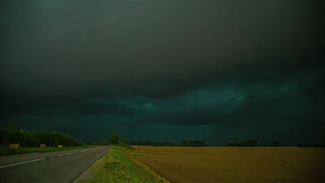 Dramatic-dark-storm-clouds-in-timelapse-over-rye-fields
