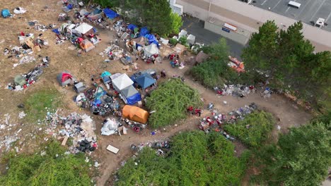 Overhead-drone-shot-of-a-homeless-camp-in-Washington-State-with-trash-spread-across-the-ground