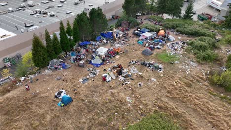 Aerial-shot-of-a-homeless-camp-with-tents-and-trash-spread-everywhere
