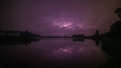 Time-lapse-of-a-lake-with-a-starry-sky-at-dusk-turning-into-a-stormy-one-as-vehicles-pass-over-a-bridge