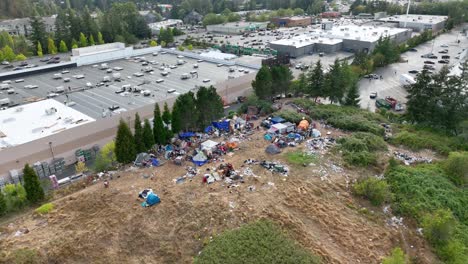 Aerial-view-of-a-homeless-camp-situated-right-behind-a-large-shopping-complex-in-Bellingham,-Washington