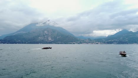 FPV-drone-shot-following-speedboat-on-Lake-Como-in-Italian-Alps
