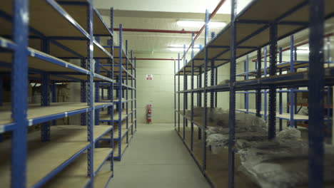Empty-shelves-in-a-warehouse-aisle
