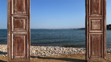 Seafront-wooden-door-on-beach-for-shooting-venue-facing-sea