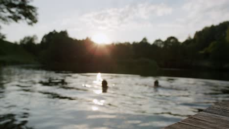 Static-view-of-two-friends-chilling-on-lake-in-blurry-background-at-sunset