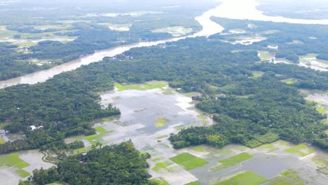 High-view-over-river-overflowed-after-heavy-rain-and-flooded-agricultural-fields,-Bangladesh