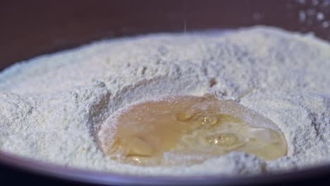 Flour-goes-everywhere-as-a-raw-egg-is-dropped-onto-a-plate