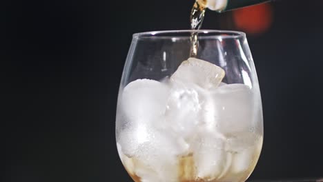 Straight-alcoholic-spirit-is-poured-into-a-glass-full-of-ice-cubes