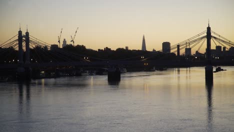 London-Thames-north-bank-dawn-skyline-through-Albert-Bridge-from-Battersea-Bridge-4K