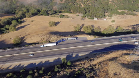 Truck-alongside-the-highway-in-need-of-roadside-assistance-and-repair---aerial-parallax