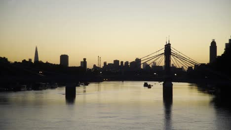 London-Thames-dawn-skyline-through-Albert-Bridge-from-Battersea-Bridge-looking-towards-Vauxhall-4K