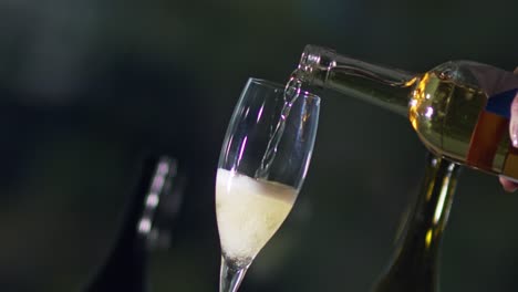 Tilted-clip-pouring-chilled-champagne-from-a-bottle-into-a-clear-glass-flute