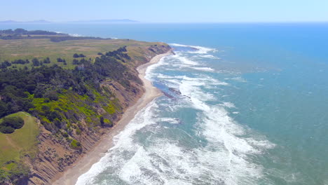 Aerial-view-of-cliffs-by-the-sea-shore-in-RCA-beach-in-California,-USA