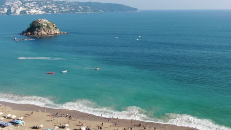 Aerial-shot-of-a-beach-and-rock-in-Acapulco-Mexico