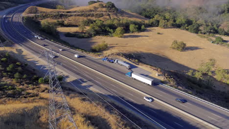 Broken-down-truck-on-a-foggy-morning-along-a-highway-near-San-Luis-Obispo,-California---aerial-orbit