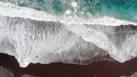 Ocean-waves-slowly-washing-sandy-beach-of-Azores,-overhead-flyover
