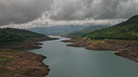 Hornito-Panama-Aerial-v2-cinematic-natural-landscape-capturing-beautiful-pristine-fortuna-reservoir,-brazo-de-hornito-with-dense-and-dark-stormy-clouds-in-the-sky---Shot-with-Mavic-3-Cine---April-2022
