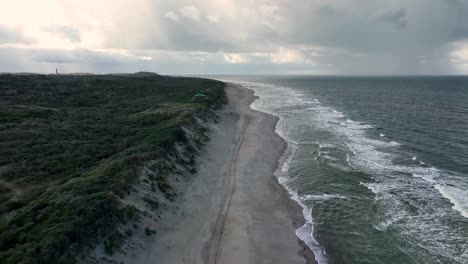 Aerial-view-of-a-remote,-sandy-beach-in-Holland-on-a-cloudy-day