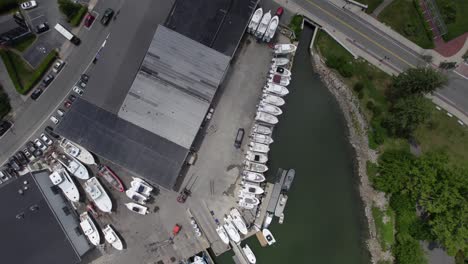 Aerial-view-rotating-over-boats-at-the-Safe-Harbor-Plymouth-marina,-USA---top-down,-drone-shot