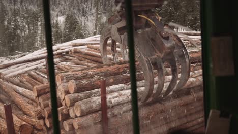 First-person-POV-blue-collar-tradesman-operates-industrial-timber-logging-manipulator-arm-claw-tractor-from-inside-cabin-with-joystick-3