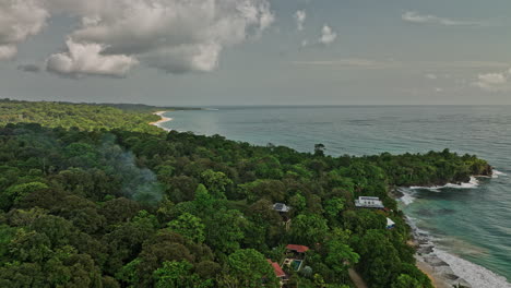 Bocas-del-Toro-Panama-Aerial-v5-elevation-drone-flyover-paunch,-reveal-shot-capturing-beautiful-summer-paradise-secluded-bluff-beach-with-turquoise-blue-seascape---Shot-with-Mavic-3-Cine---April-2022