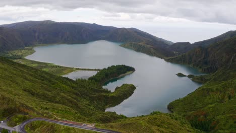 Woody-slopes-of-Lagoa-di-Fogo-crater-lake-in-Azores,-aerial-panorama