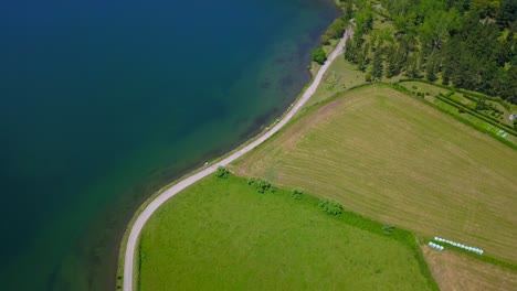 Aerial-drone-view-of-dirty-road-in-shores-of-Sete-Cidades-lake-in-Sao-Miguel,-Azores