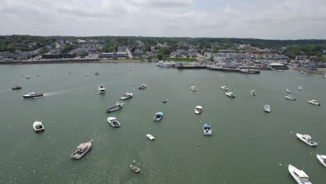 Aerial-view-over-moored-boats-towards-the-town-of-Plymouth,-sunny-day-in-USA