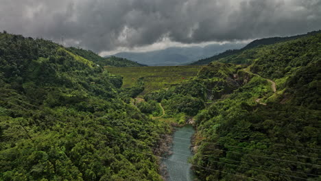 Hornito-Panama-Aerial-v7-cinematic-flyover-along-brazo-de-hornito-river-leading-to-fortuna-reservoir-dam-with-hillside-dense-lush-green-vegetations-and-stormy-sky---Shot-with-Mavic-3-Cine---April-2022