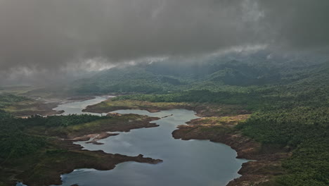 Hornito-Panama-Aerial-v4-drone-flyover-dense-thick-clouds,-cinematic-transitioning-reveal-fortuna-reservoir-dam-and-beautiful-winding-river-landscape---Shot-with-Mavic-3-Cine---April-2022